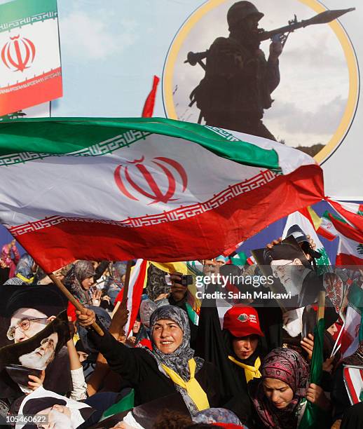 Woman waves a flag during a rally with Iranian President Mahmoud Ahmadinejad during his visit October 14, 2010 in the village of Bint Jbeil, Lebanon...