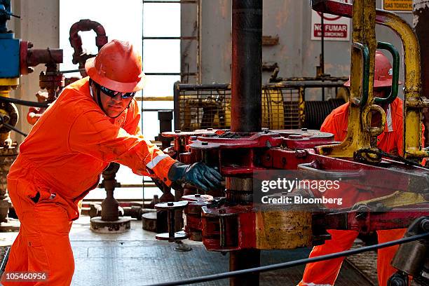 Workers guide drill pipe aboard the Petroleos Mexicanos Tonala jack-up rig in the Ku-Maloob-Zaap oil field in the Gulf of Mexico 65 miles northeast...