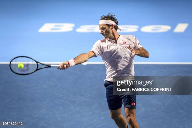 Switzerland's Roger Federer returns a ball to Romania's Marius Copil during their final match at the Swiss Indoors ATP 500 tennis tournament on...