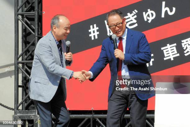 SoftBank Group CEO Masayoshi Son and Toyota Motor Co President Akio Toyoda shake hands during a talk show of the Tokyo Motor Fes 2018 at DiverCity...