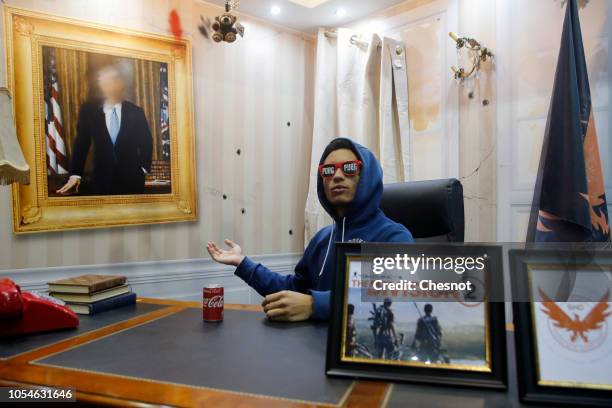 Visitor poses for a picture in the video game scenery "Tom Clancy's The Division 2" during the 'Paris Games Week' on October 28, 2018 in Paris,...