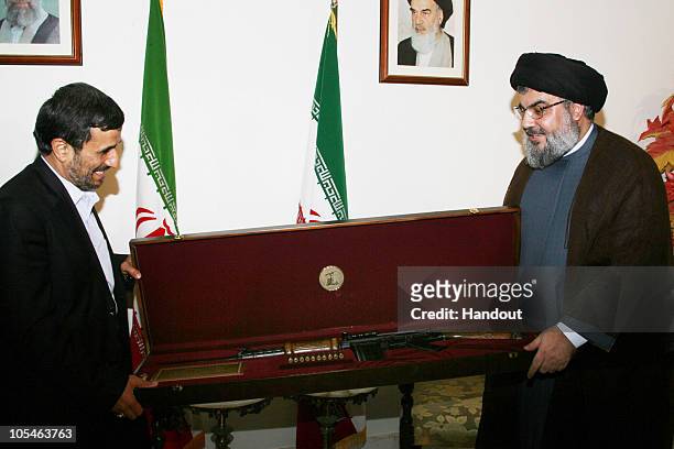 In this image released by the Hezbollah Media Office, Hezbollah Secretary General Sayyed Hassan Nasrallah , presents Iranian President Mahmoud...