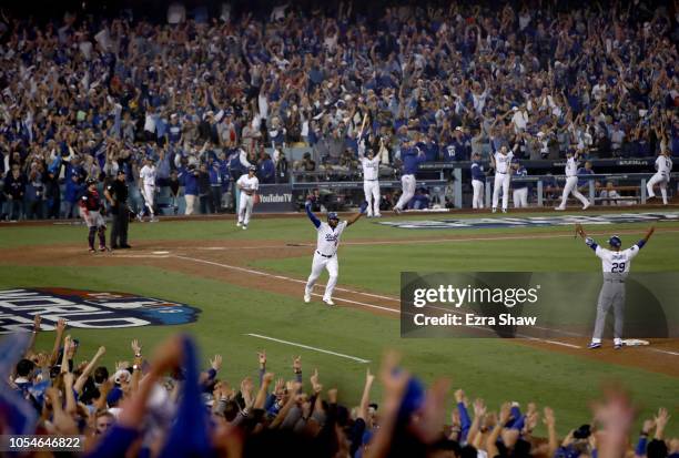 Yasiel Puig of the Los Angeles Dodgers celebrates on his way to first base after hitting a three-run home run to left field in the sixth inning of...