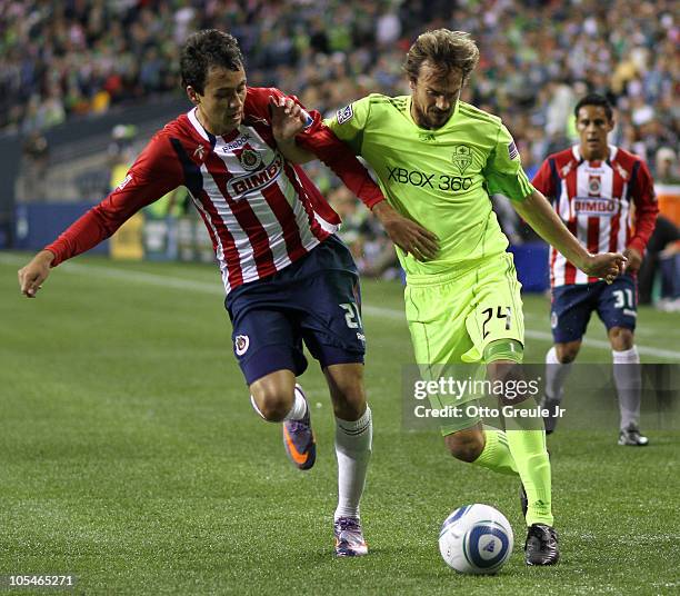 Roger Levesque of the Seattle Sounders FC dribbles against Christian Perez of Chivas de Guadalajara on October 12, 2010 at Qwest Field in Seattle,...