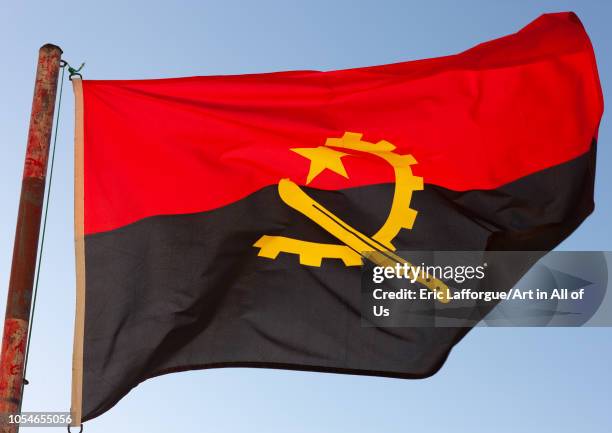 Angolan flag in the wind, Namibe Province, Tombua, Angola on November 29, 2010 in Tombua, Angola.