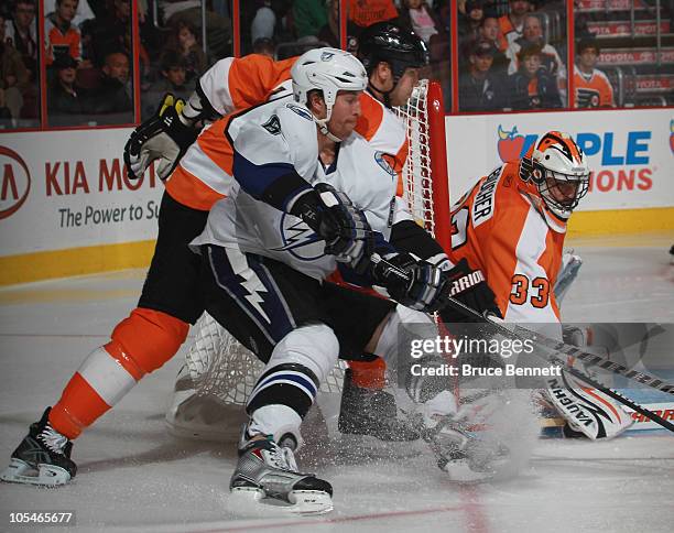 Brian Boucher and Chris Pronger of the Philadelphia Flyers defend against Ryan Malone of the Tampa Bay Lightning at the Wells Fargo Center on October...