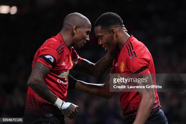 Anthony Martial celebrates with teammate Ashley Young after scoring his teams second goal during the Premier League match between Manchester United...