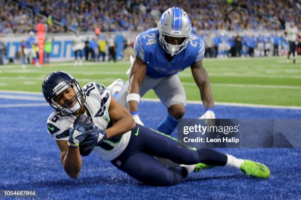 Tyler Lockett of the Seattle Seahawks catches a touchdown pass infront of Nevin Lawson of the Detroit Lions during the second quarter at Ford Field...