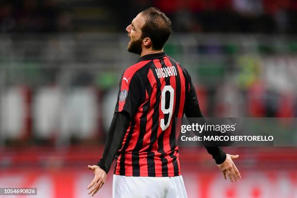 Milan's Argentinian forward Gonzalo Higuain celebrates after scoring during the Italian Serie A football match AC Milan vs Sampdoria at the 'Giuseppe...