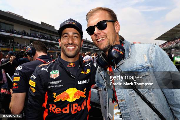 Daniel Ricciardo of Australia and Red Bull Racing talks with superstar DJ Armin van Buuren on the grid before the Formula One Grand Prix of Mexico at...