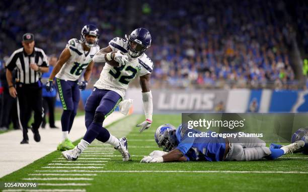 Christian Jones of the Detroit Lions tries to tackle Chris Carson of the Seattle Seahawks during the second half at Ford Field on October 28, 2018 in...