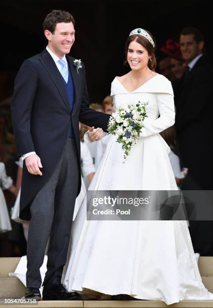 Jack Brooksbank and Princess Eugenie leave St George's Chapel after their wedding ceremony on October 12, 2018 in Windsor, England.