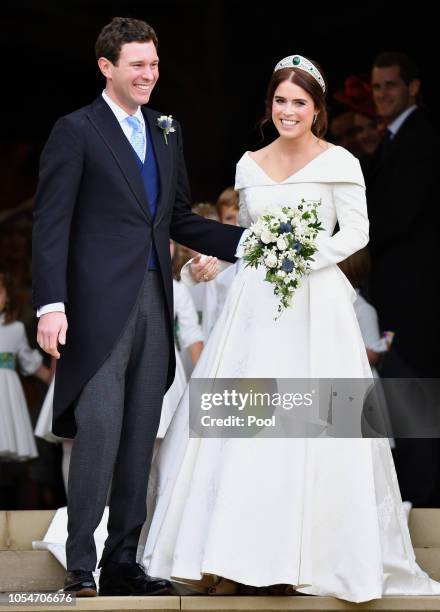 Jack Brooksbank and Princess Eugenie leave St George's Chapel after their wedding ceremony on October 12, 2018 in Windsor, England.