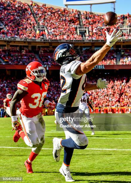 Jeff Heuerman of the Denver Broncos reaches out trying to make a catch in from of Ron Parker of the Kansas City Chiefs during the second half of the...