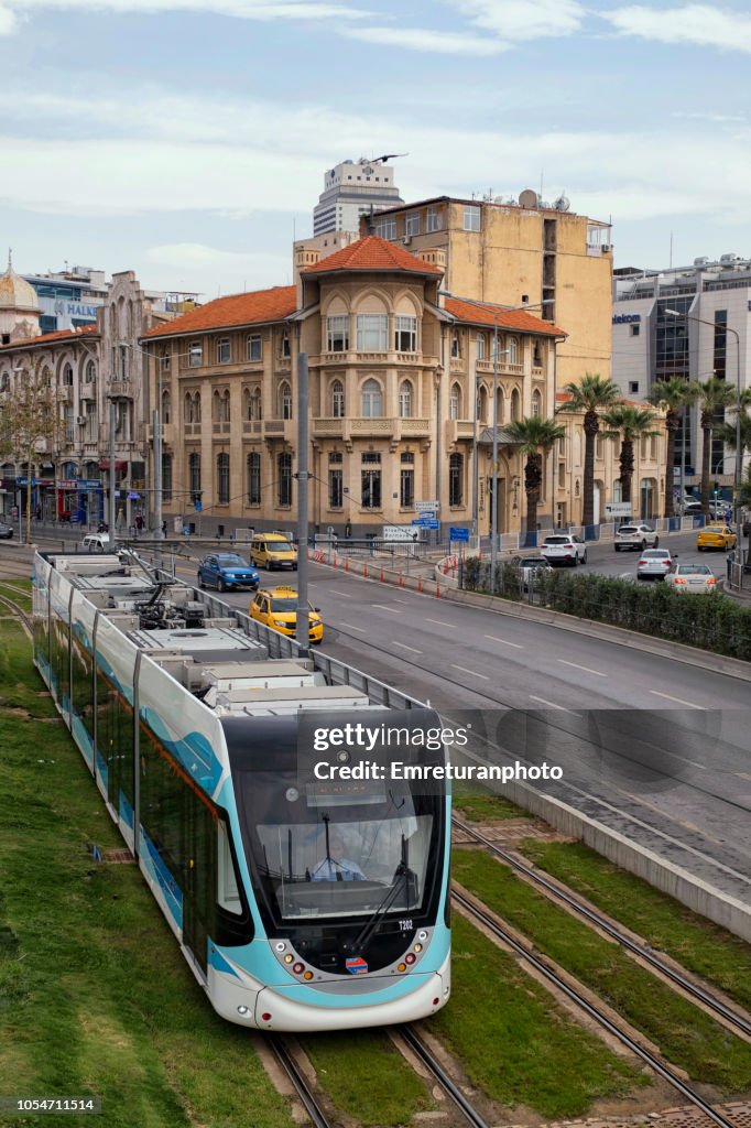 Cable car moving next to car traffic on Cumhuriyet Boulevard near Konak square,Izmir.