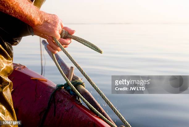fisherman holding net, close up - fishing imagens e fotografias de stock