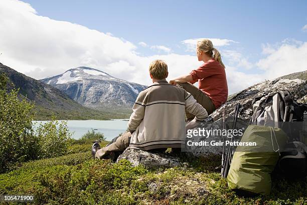couple with camping equipment overlooking scenery - trondheim norway stock pictures, royalty-free photos & images