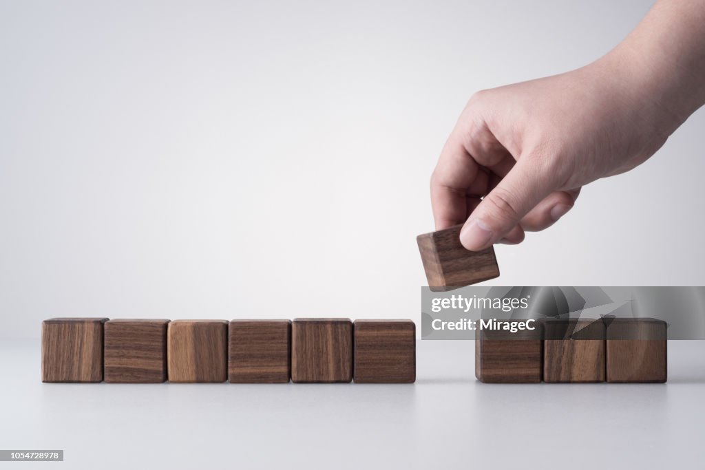 Hand Removing a Wood Blocks