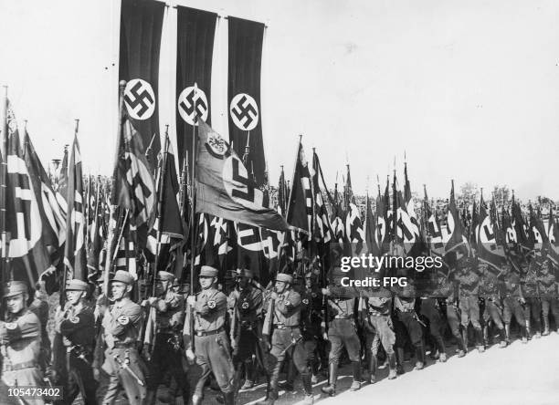 Members of the Nazi Sturmabteilung marching down the Luitpoldhain with their banners at the Nuremberg Rally to mark the 6th Nazi Party Congress, 9th...