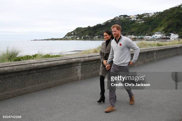 Prince Harry, Duke of Sussex and Meghan, Duchess of Sussex walking along Lyall Bay to visit Maranui Cafe on October 29, 2018 in Wellington, New...