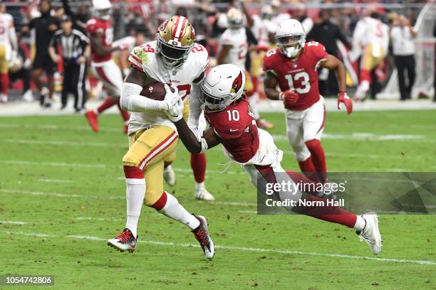 Strong safety Jaquiski Tartt of the San Francisco 49ers is tackled by wide receiver Chad Williams of the Arizona Cardinals while returning an...