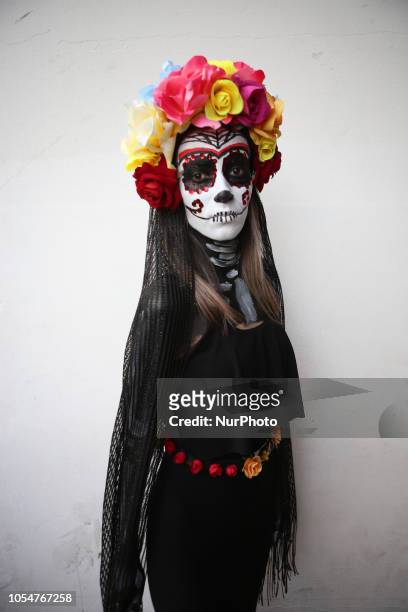 People dressed as Catrin and Catrina pose for photo in festival celebrating the day of Los Muertos in Sao Paulo on October 28, 2018.