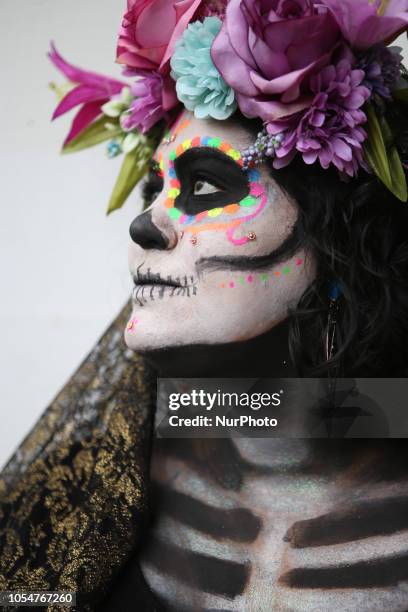 People dressed as Catrin and Catrina pose for photo in festival celebrating the day of Los Muertos in Sao Paulo on October 28, 2018.