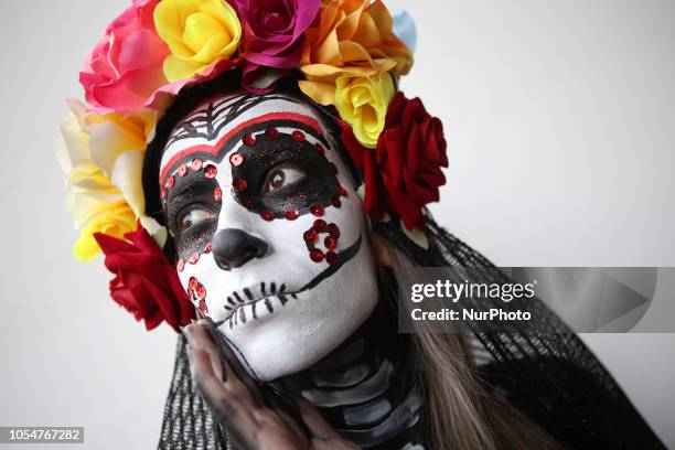 People dressed as Catrin and Catrina pose for photo in festival celebrating the day of Los Muertos in Sao Paulo on October 28, 2018.