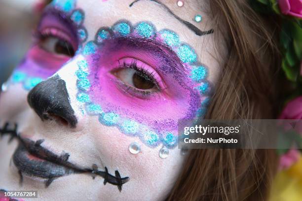 People dressed as Catrin and Catrina pose for photo in festival celebrating the day of Los Muertos in Sao Paulo on October 28, 2018.