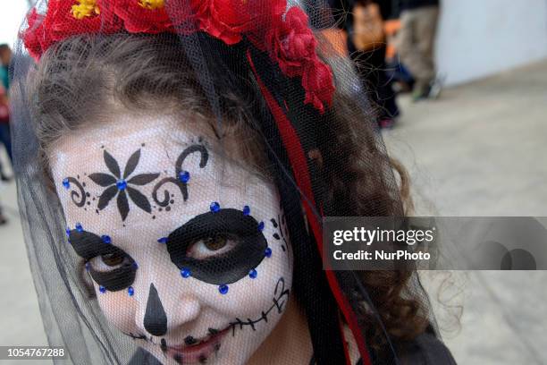 People dressed as Catrin and Catrina pose for photo in festival celebrating the day of Los Muertos in Sao Paulo on October 28, 2018.