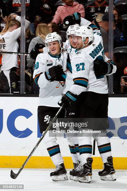 Marcus Sorensen, Timo Meier, and Joonas Donskoi of the San Jose Sharks celebrate Meier's game-winning overtime goal against the Anaheim Ducks on...