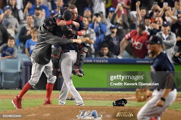 Christian Vazquez and David Price embrace Chris Sale of the Boston Red Sox to celebrate their 5-1 win over the Los Angeles Dodgers in Game Five to...