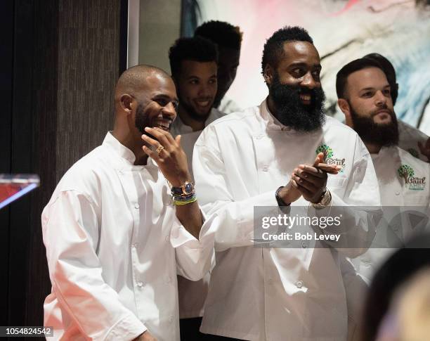 Chris Paul and James Harden of the Houston Rockets prepares to serve guests at the Chris Paul Family Foundation's "Celebrity Server" Fundraiser at...
