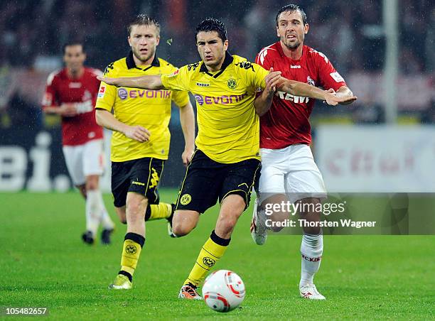 Fabrice Ehret of Koeln battles for the ball with Nuri Sahin of Dortmund during the Bundesliga match between 1.FC Koeln and Borussia Dortmund at...