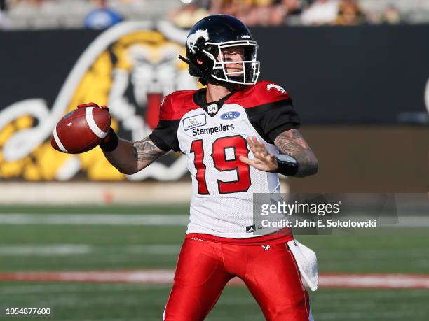 Bo Levi Mitchell of the Calgary Stampeders looks to pass against the Hamilton Tiger-Cats during a game at Tim Hortons Field on September 15, 2018 in...