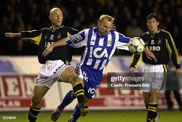 Gothenburg player Hakan Mild protects the ball from AIK player Mattias Thylander during a game in the Swedish Premier League match at the Rasunda...