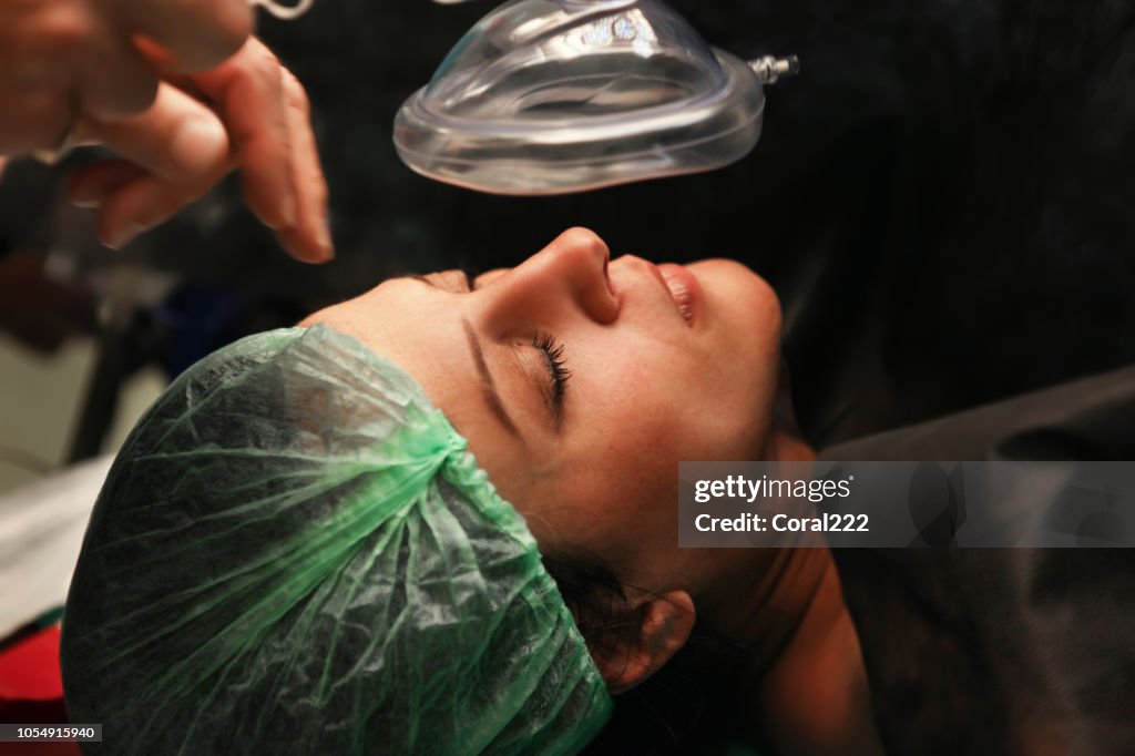 Patient being sedated by anesthesiologist before surgical procedure