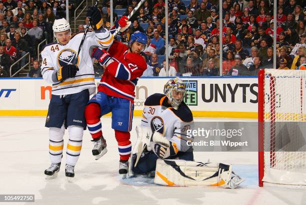Brian Gionta of the Montreal Canadiens gets in betweeen Andrej Sekera and Ryan Miller of the Buffalo Sabres as Josh Gorges of the Canadiens scores a...