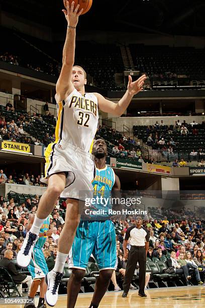 Josh McRoberts of the Indiana Pacers lays the ball up on Pops Mensha-Bonsu of the New Orleans Hornets on October 15, 2010 at Conseco Fieldhouse in...