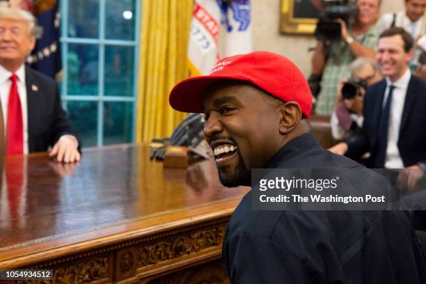 Rapper Kanye West laughs during a meeting with President Donald Trump in the Oval Office of the White House in Washington D.C. On October 11, 2018.