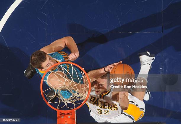 Josh McRoberts of the Indiana Pacers battles Jason Smith of the New Orleans Hornets on October 15, 2010 at Conseco Fieldhouse in Indianapolis,...