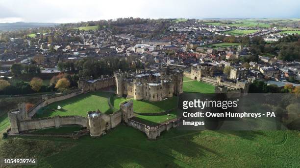 An aerial view of a Alnwick Castle, Northumberland, surrounded by autumn colours.