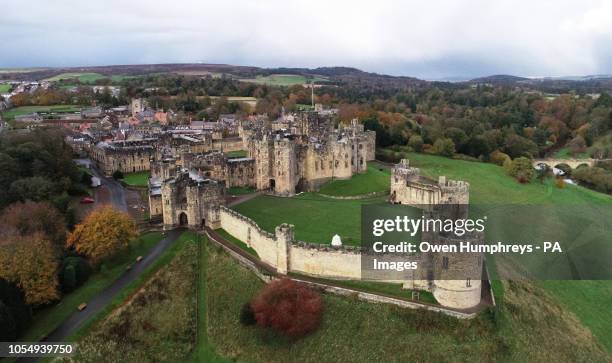 An aerial view of a Alnwick Castle, Northumberland, surrounded by autumn colours.