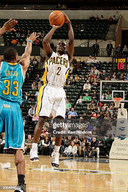 Darren Collison of the Indiana Pacers shoots over Willie Green of the New Orleans Hornets on October 15, 2010 at Conseco Fieldhouse in Indianapolis,...