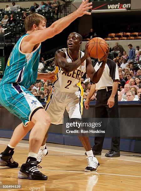 Darren Collison of the Indiana Pacers looks to pass around Aaron Gray of the New Orleans Hornets on October 15, 2010 at Conseco Fieldhouse in...