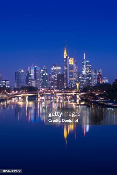 frankfurt city skyline and main river reflection illuminated at twilight, germany - frankfurt germany skyline stock pictures, royalty-free photos & images