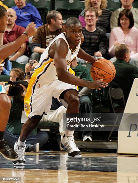 Darren Collison of the Indiana Pacers brings the ball up court against the New Orleans Hornets on October 15, 2010 at Conseco Fieldhouse in...