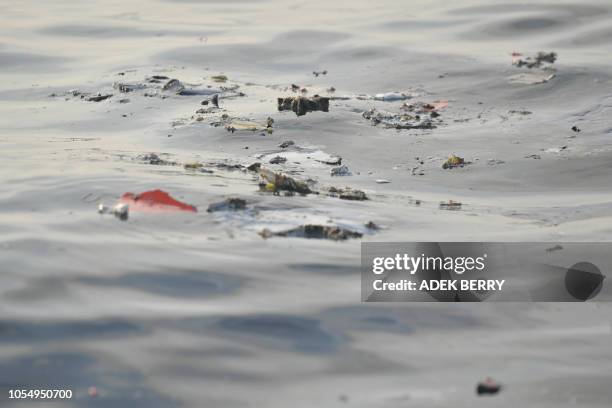 Debris from the ill-fated Lion Air flight JT 610 floats at sea in the waters north of Karawang, West Java province, on October 29, 2018. - All 189...