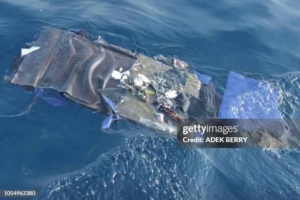 Debris from the ill-fated Lion Air flight JT 610 floats at sea in the waters north of Karawang, West Java province, on October 29, 2018. - All 189...