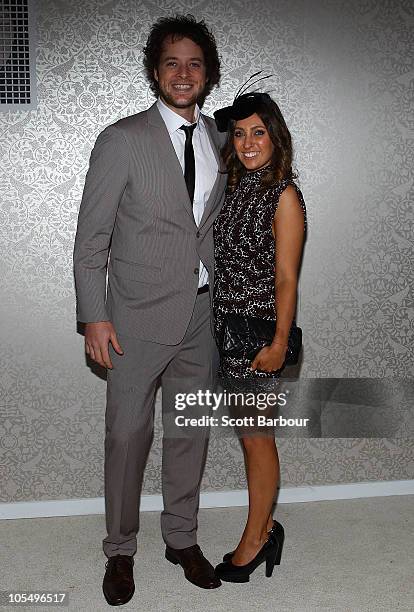 Hamish Blake poses with girlfriend Zoe Foster as they attend BMW Caulfield Cup Day at Caulfield Racecourse on October 16, 2010 in Melbourne,...